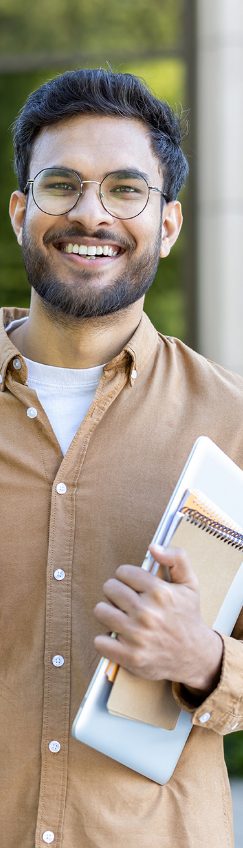 Young professional carrying a notebook and tablet